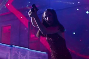 woman taking aim with a gun in a nightclub