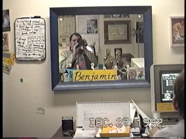 A screen capture from a 1992 Benj Edwards home video. Benj's dad is in the mirror videotaping Benj using the Prodigy online service after getting it as a Christmas gift in 1992.