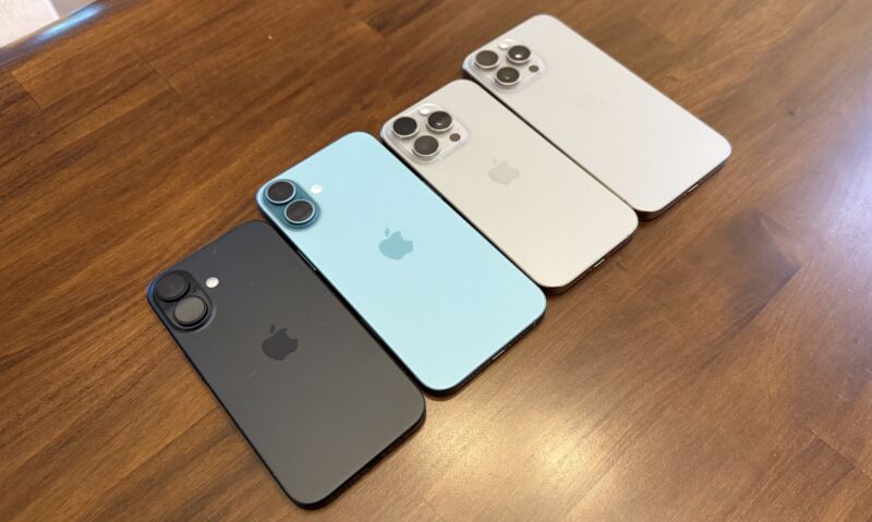 Four iPhones on a wood table