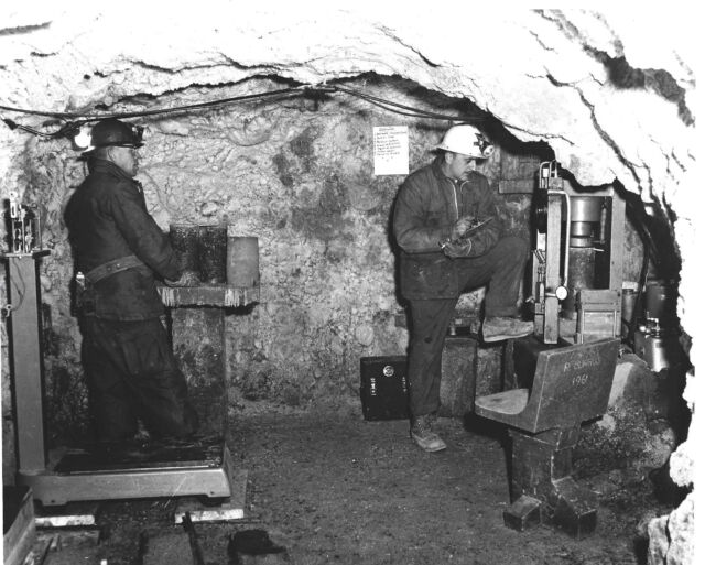 US Army engineers test permacrete strength in a tunnel cut into the frozen soil beneath the Greenland ice sheet in the 1960s. A permacrete chair is in the front right. 