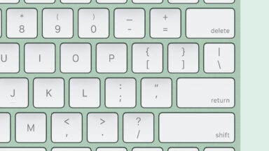 Keyboard in green, on green keyboard, with distinctive Apple Touch ID sensor in upper-right corner