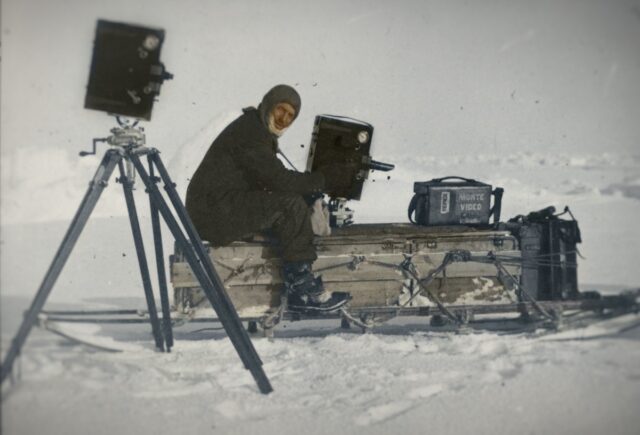 Frank Hurley with his cameras, one of which was a moving image camera: a Prestwich No. 5 cinema camera.