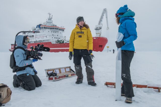 Director and producer Natalie Hewit with Stefanie Arndt, sea ice physicist, and Lucy Coulter, on the sea ice next to S.A. Agulhas II.