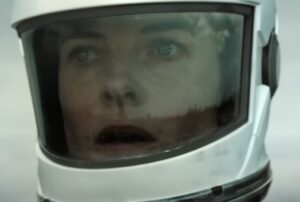 closeup of a woman in a space helmet looking shocked