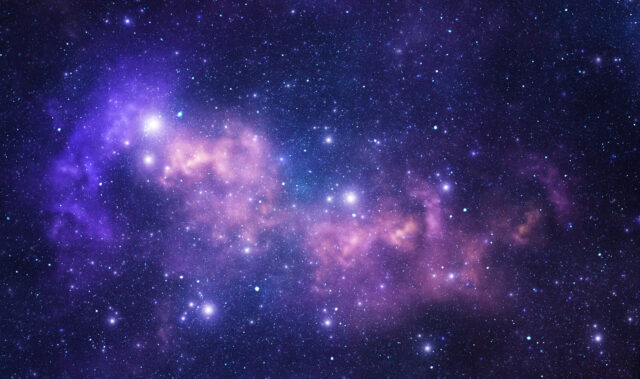 Image of a purple nebula speckled with stars against a dark backdrop.