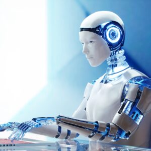 A humanoid robot sitting at a table and typing on a laptop