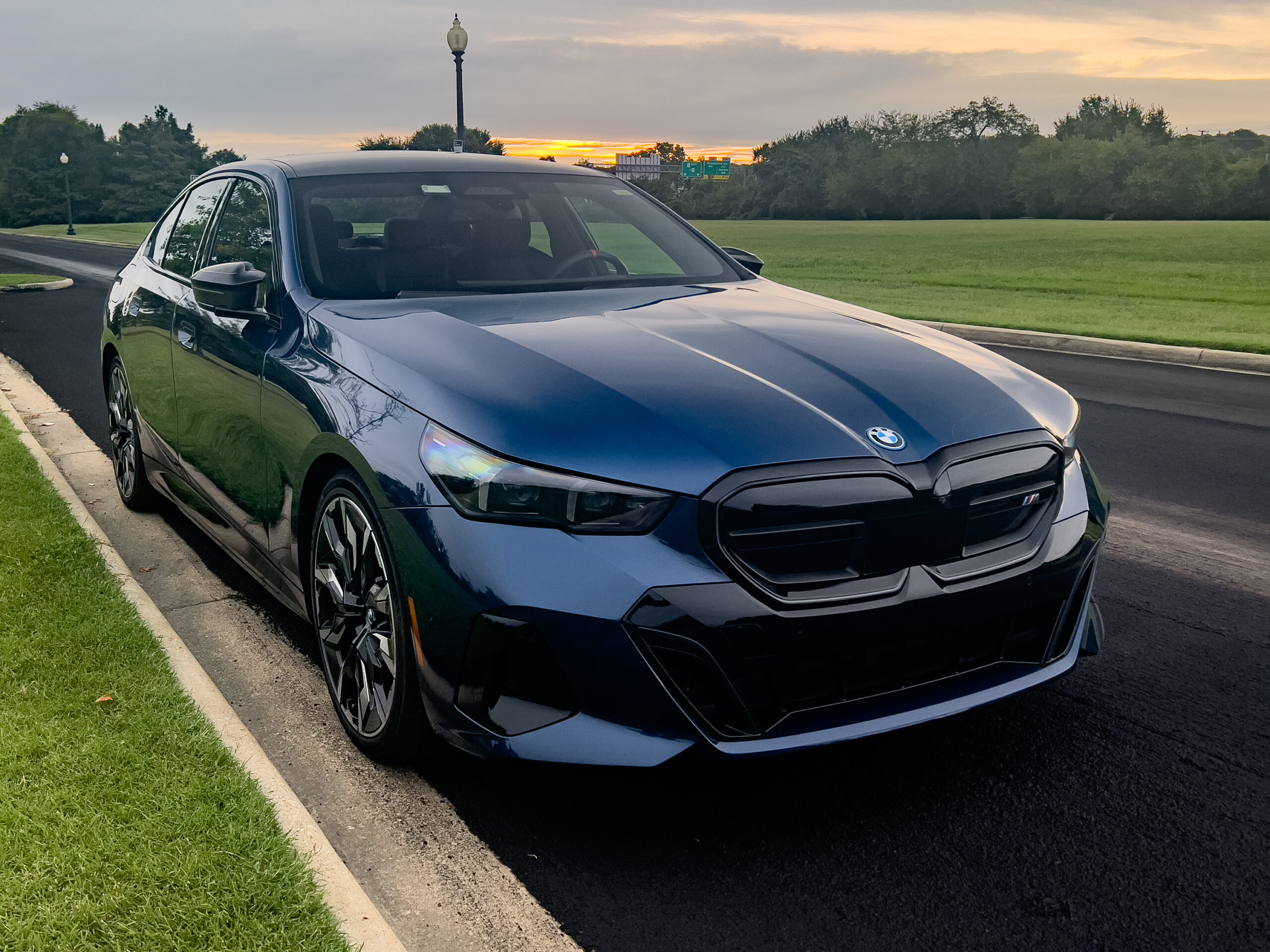 A blue BMW i5 seen in the front 3/4s