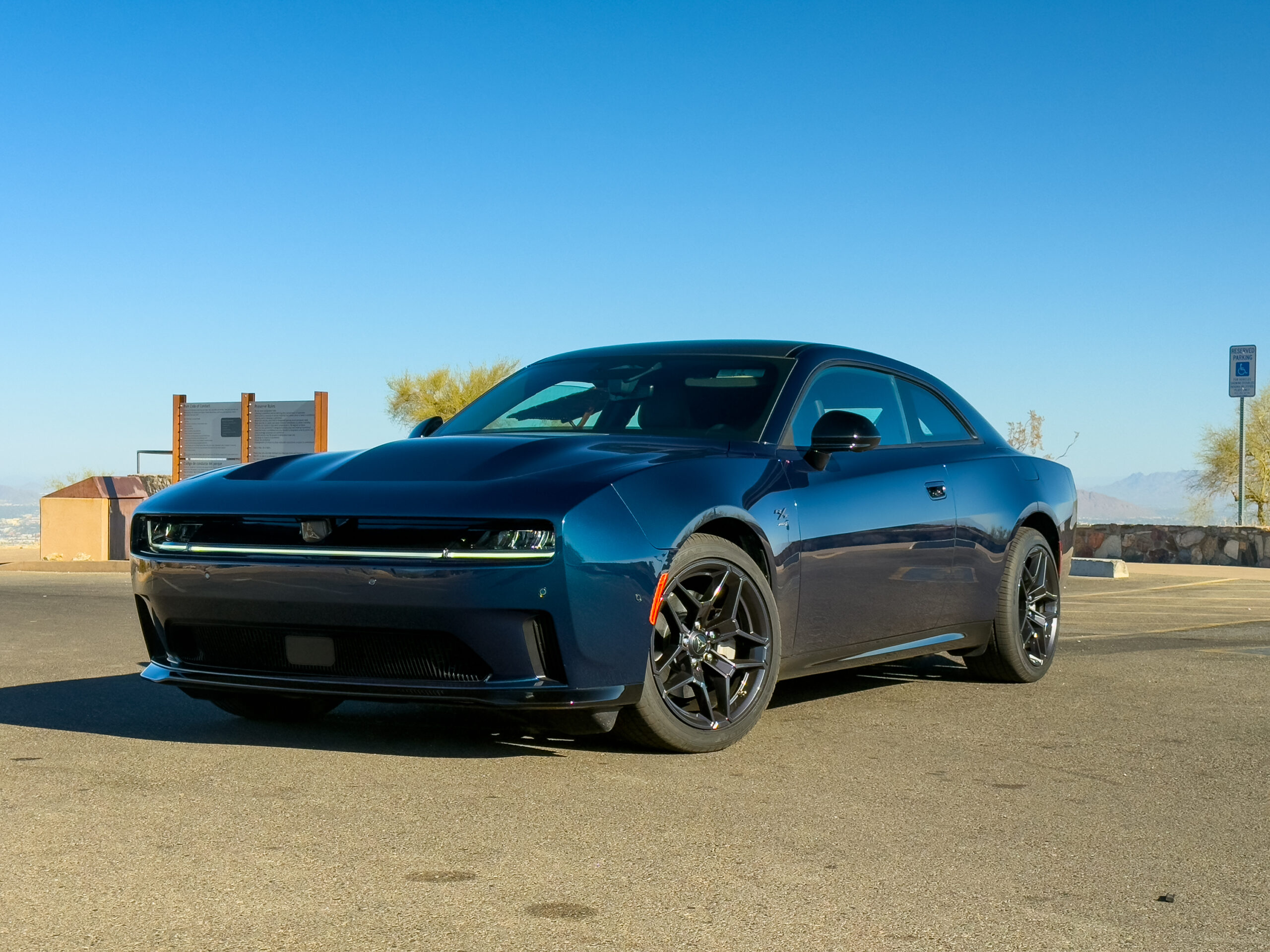 A blue Dodge Charger Daytona R/T parked at a lookout