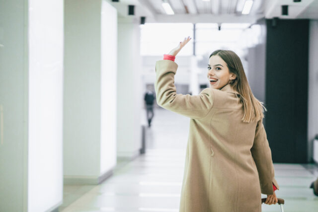 Woman waving goodbye