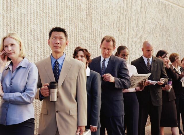 Business commuters waiting in line