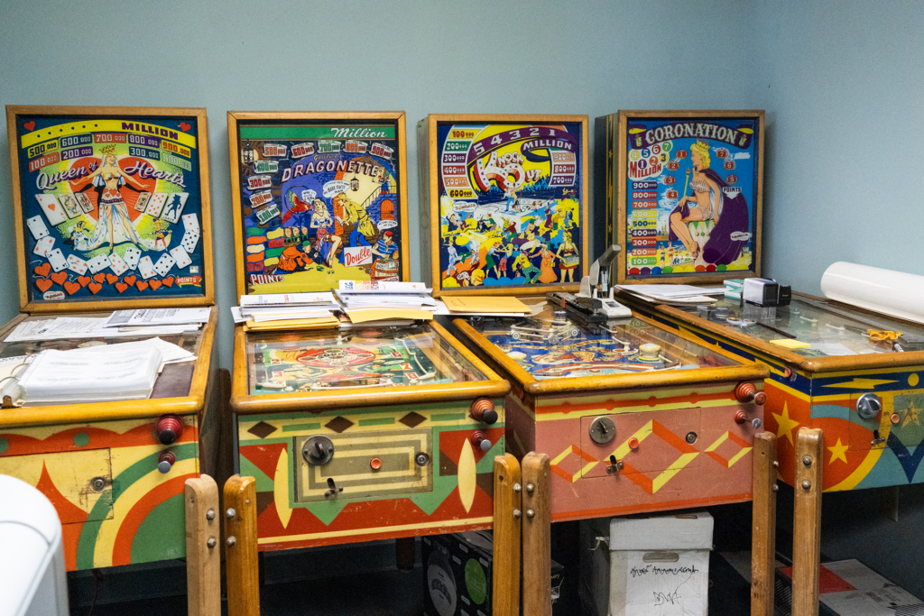 Five vintage pinball machines.