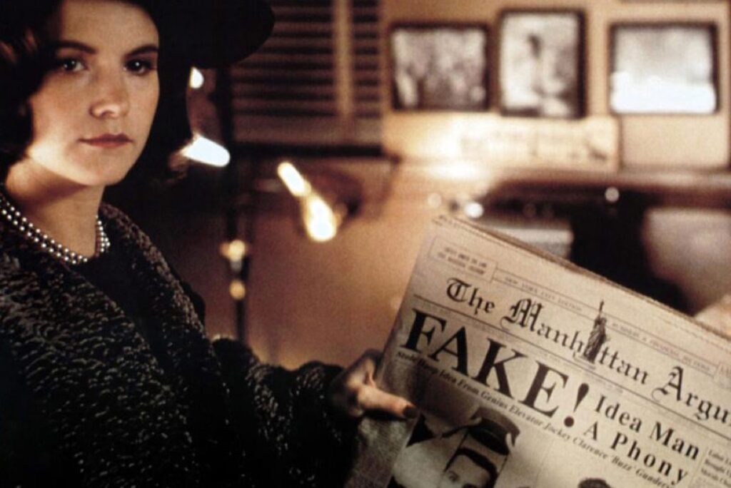 woman holding newspaper with a headline reading "FAKE"