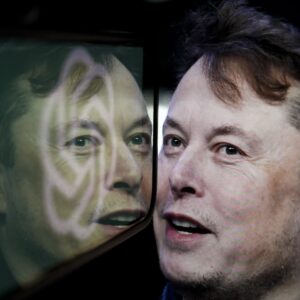 Photo illustration in which the logo of OpenAI is displayed on a mobile phone screen next to a computer screen displaying a photograph of Elon Musk.