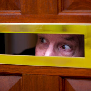 Man looks through letter flap