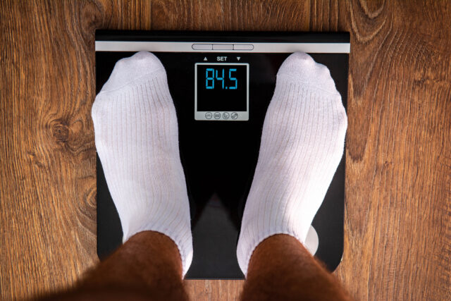 standing on a digital scale
