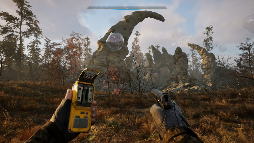 First-person perspective of holding a handgun and a yellow metal sensor, while a diffusely lit orb hovers in front of an otherworldly curve of rock coming from the ground.