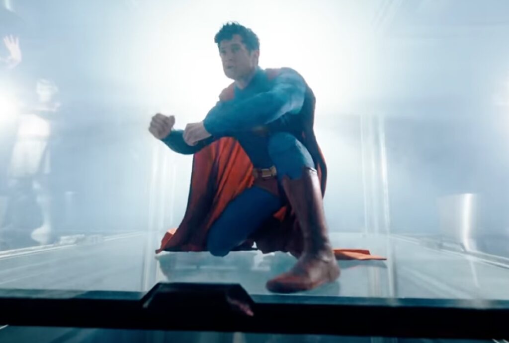 Superman crouched inside what looks like a glass cage.