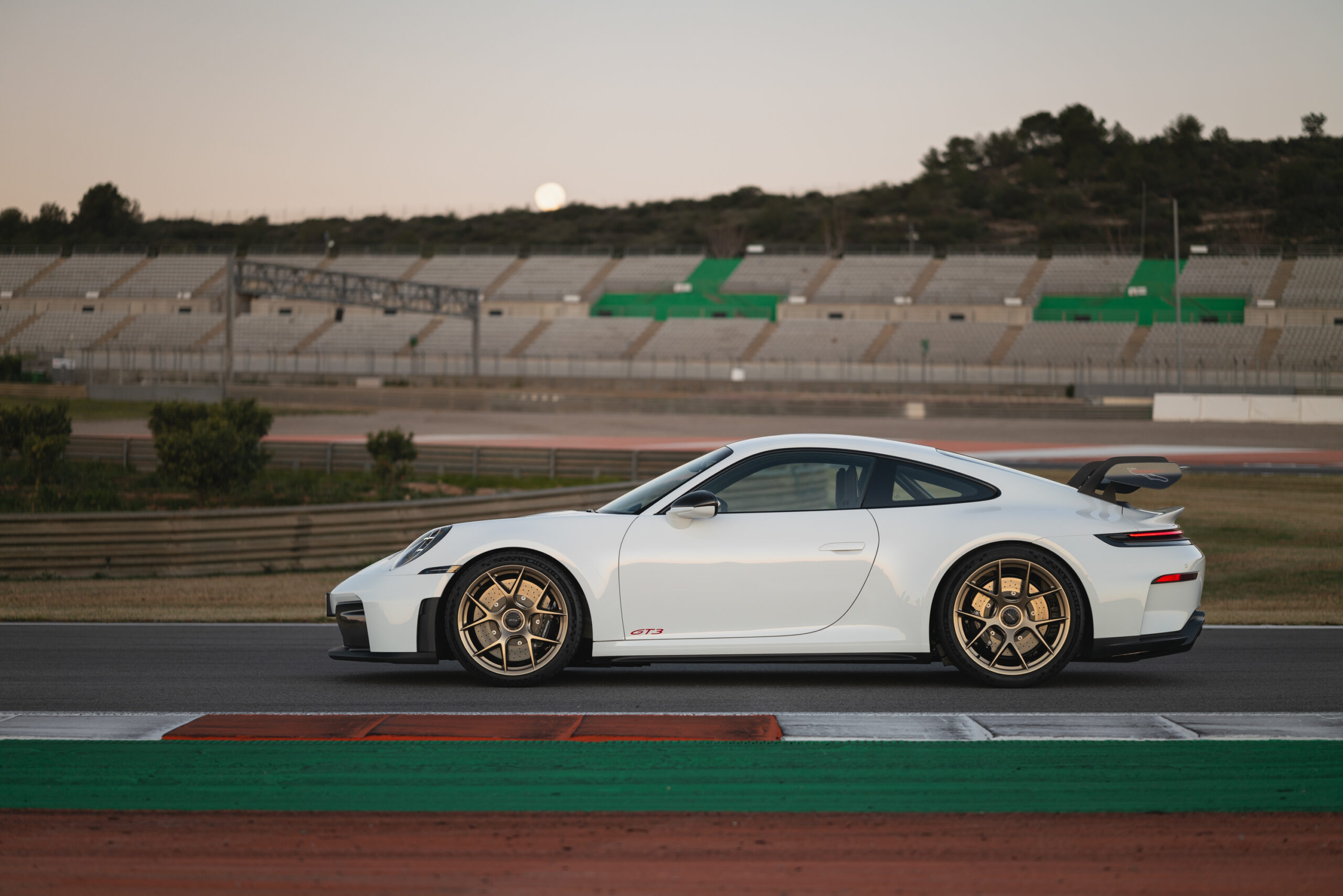 A white Porsche 911 GT3 seen in profile