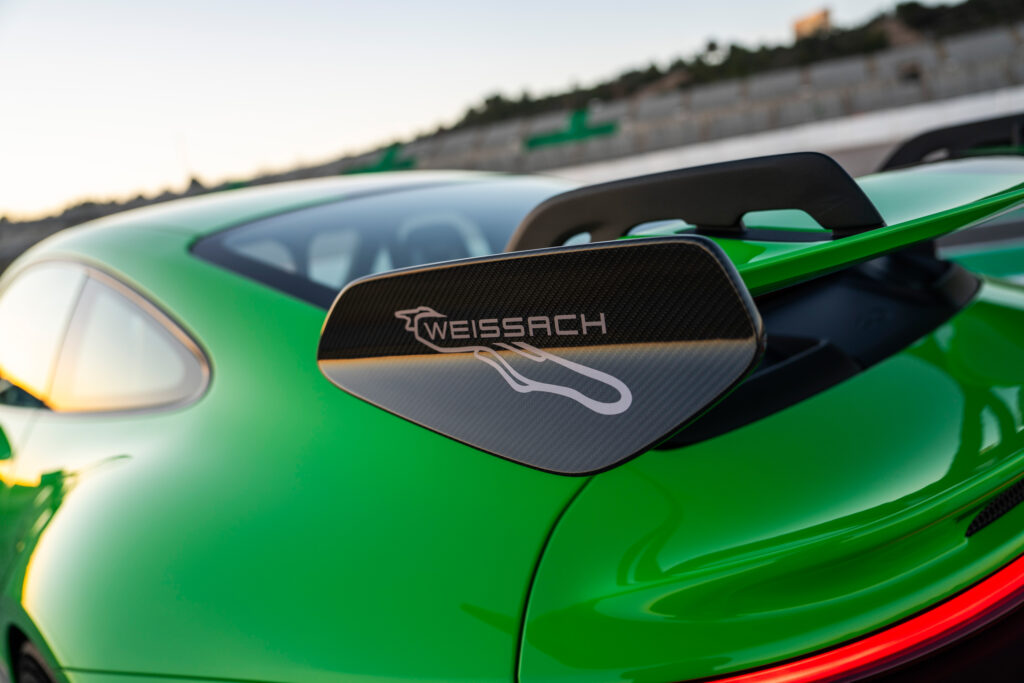 The rear wing of a green Porsche 911 GT3