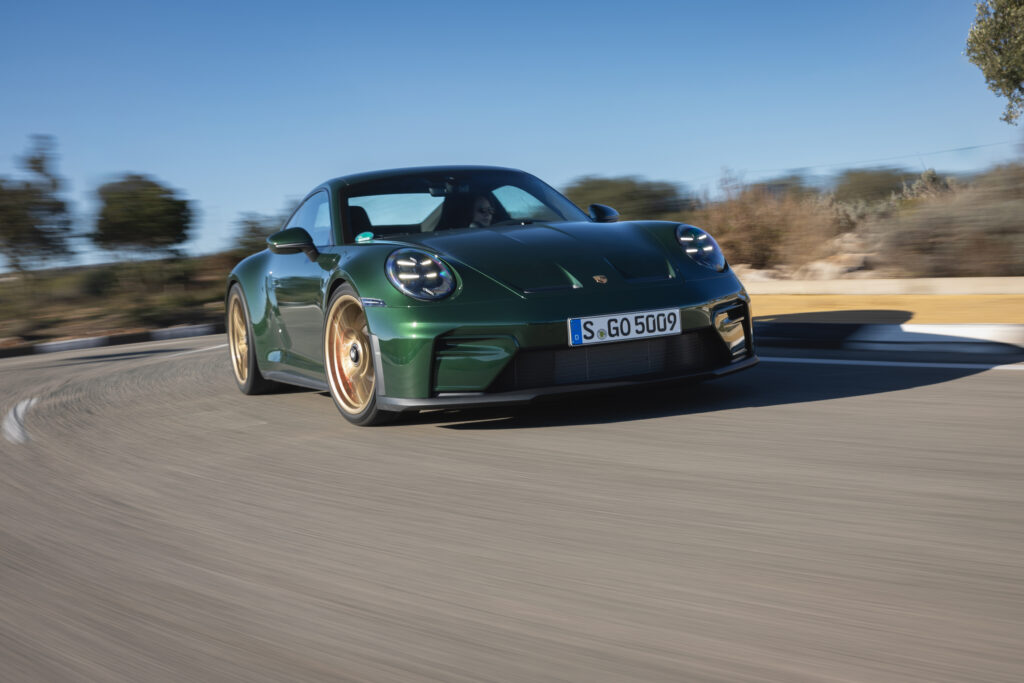 A green Porsche 911 GT3 cornering