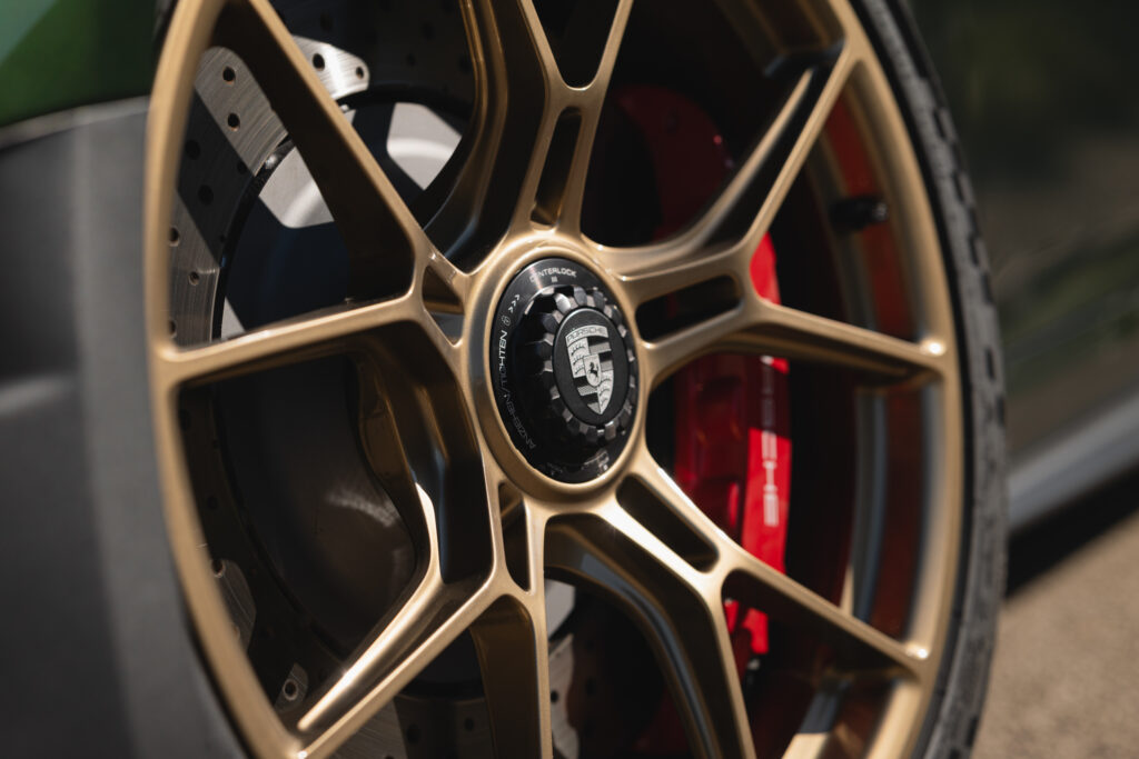 A gold-colored Porsche 911 GT3 alloy wheel