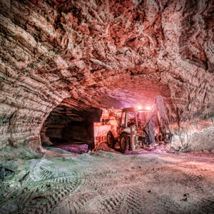 Image of an excavated area deep below ground, with some machinery furthering the excavation.