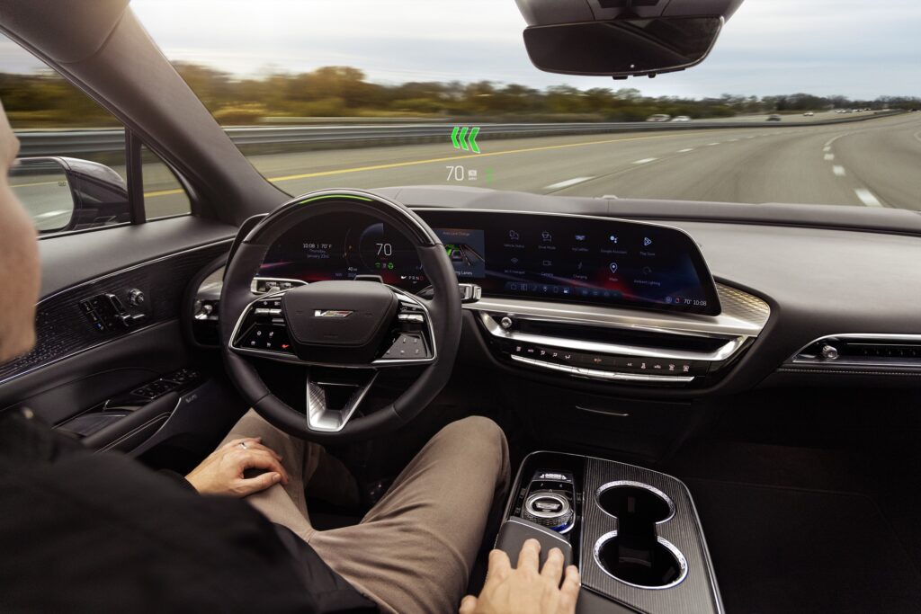 The cockpit of a Cadillac Lyriq-V. The driver is using Super Cruise.