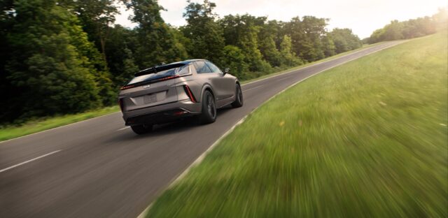 A Cadillac Lyriq-V drives away from the camera