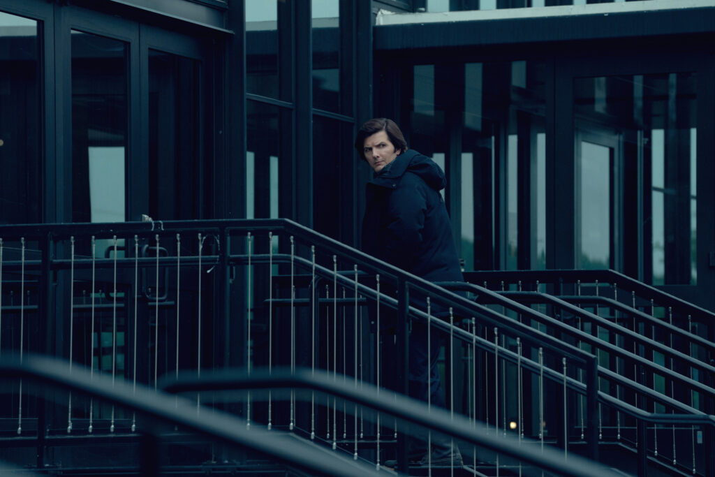 A man ascends a staircase outside an office building