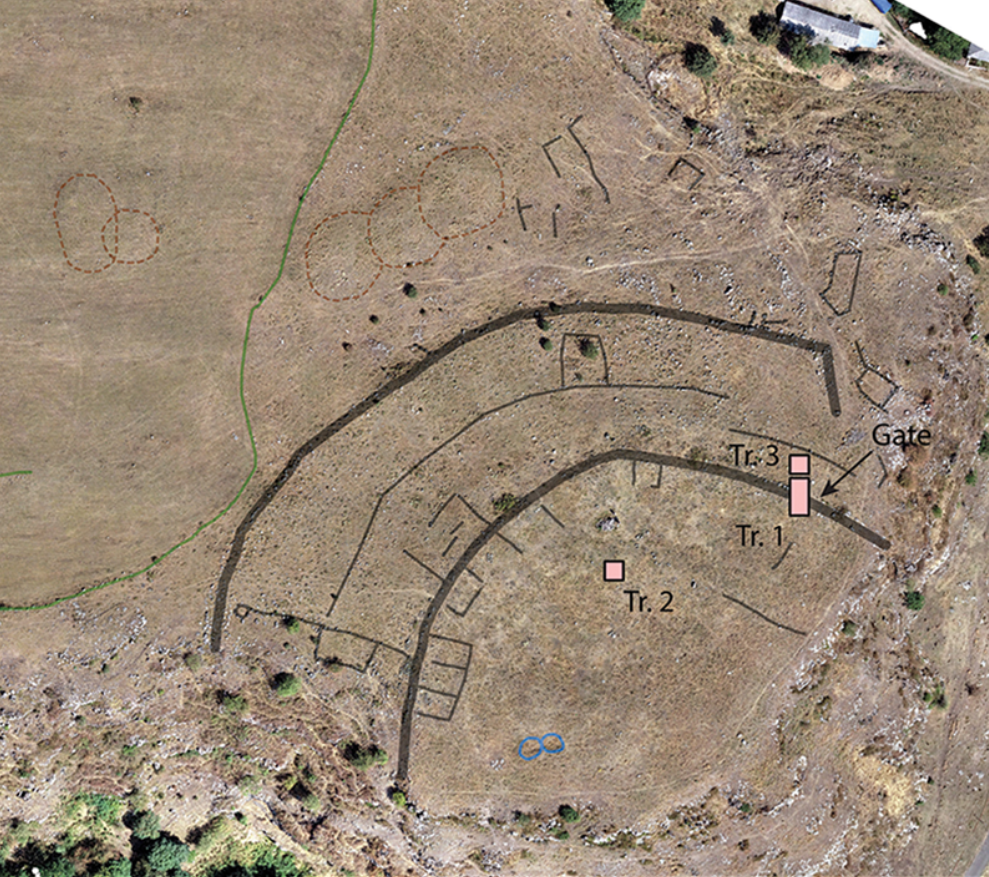 aerial photo of a brown landscape with two semicircular walls highlighted