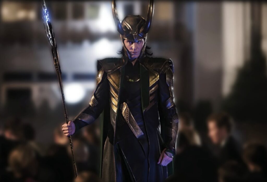 Loki in full battle garb with helmet and staff