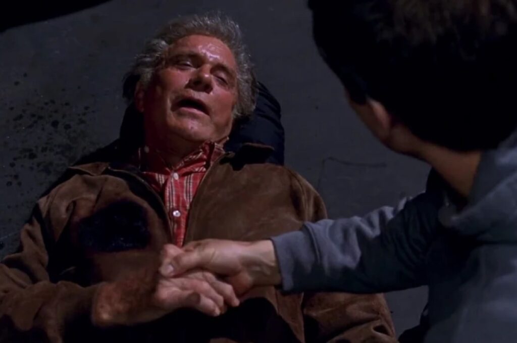 closeup of Uncle Ben dying on sidewalk while holding Peter Parker's hand