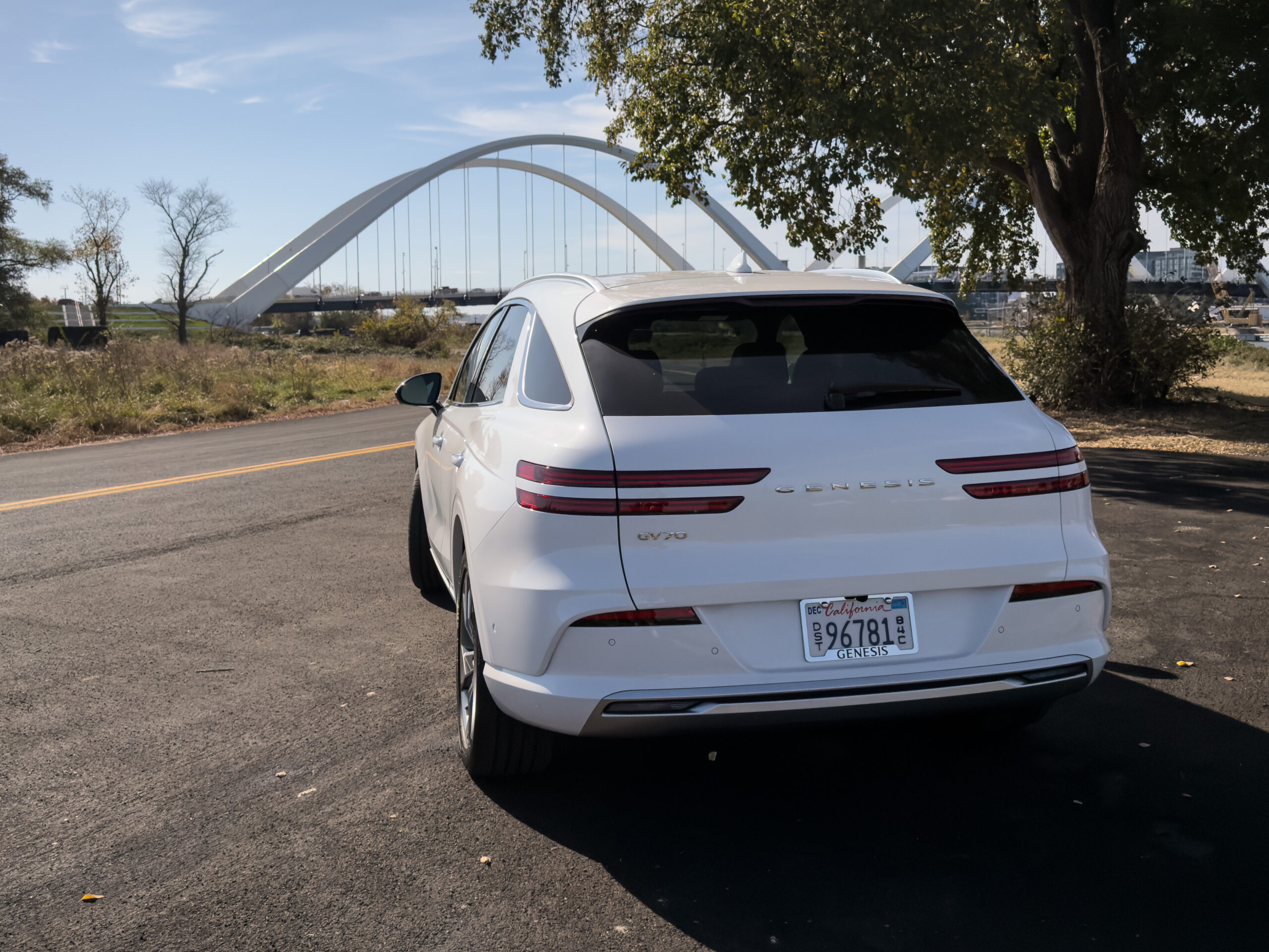 A white Genesis Electrified GV70 seen from behind.