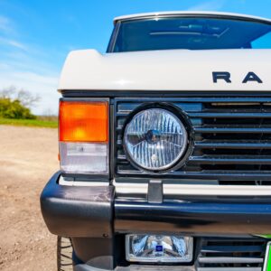 A closeup of a headlamp on an old Range Rover