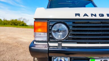 A closeup of a headlamp on an old Range Rover