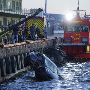 Rescue personnel retrieve a Tesla car from the water after driving out into the Oslofjord on February 1, 2024 in Oslo. Two occupants of a car that had plunged into the Oslo fjord were rescued on February 1, 2024 by a... floating sauna, the Norwegian police announced. According to an officer quoted by the media, the two occupants were unharmed.