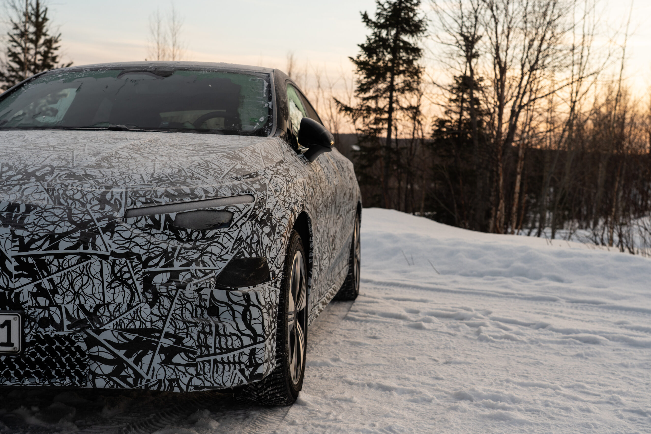 The front of a Mercedes-Benz CLA prototype in the snow.