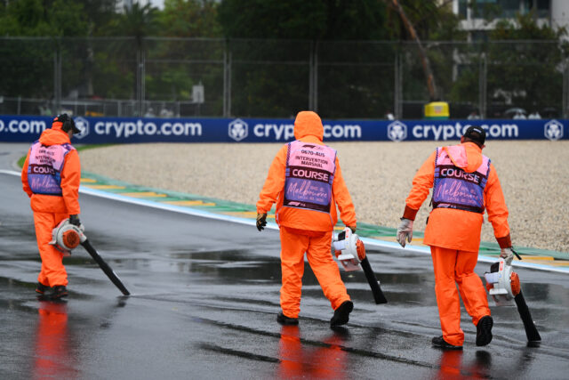 MELBOURNE, AUSTRALIA - MARCH 16: Marshals attempt to dry the trak prior to the F1 Grand Prix of Australia at Albert Park Grand Prix Circuit on March 16, 2025 in Melbourne, Australia.