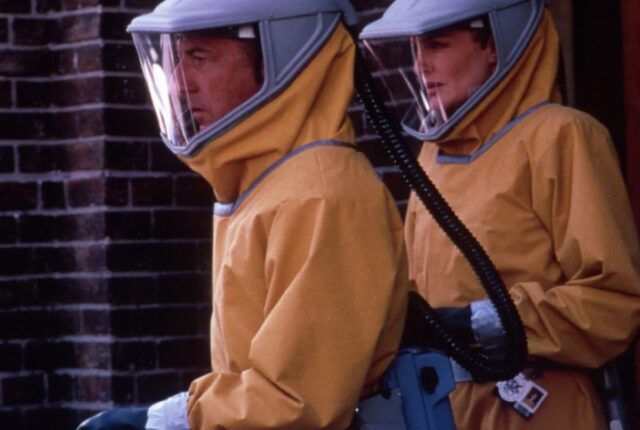 man and woman in yellow haz-mat suits; side view.