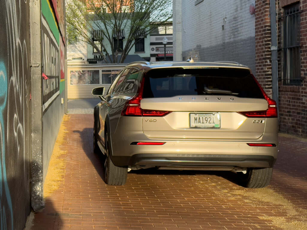 A Volvo V60 Cross Country parked in an alley, seen from the rear