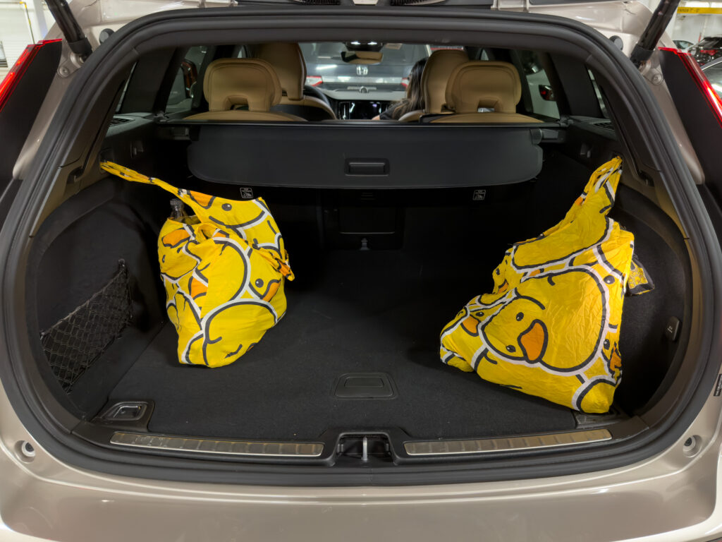 Volvo V60 Cross Country rear cargo area with two reusable shopping bags full of groceries