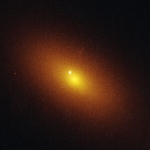 Image of a black background with a blurry orange disk at center, and a bright spot off to one side of the middle of the disk.