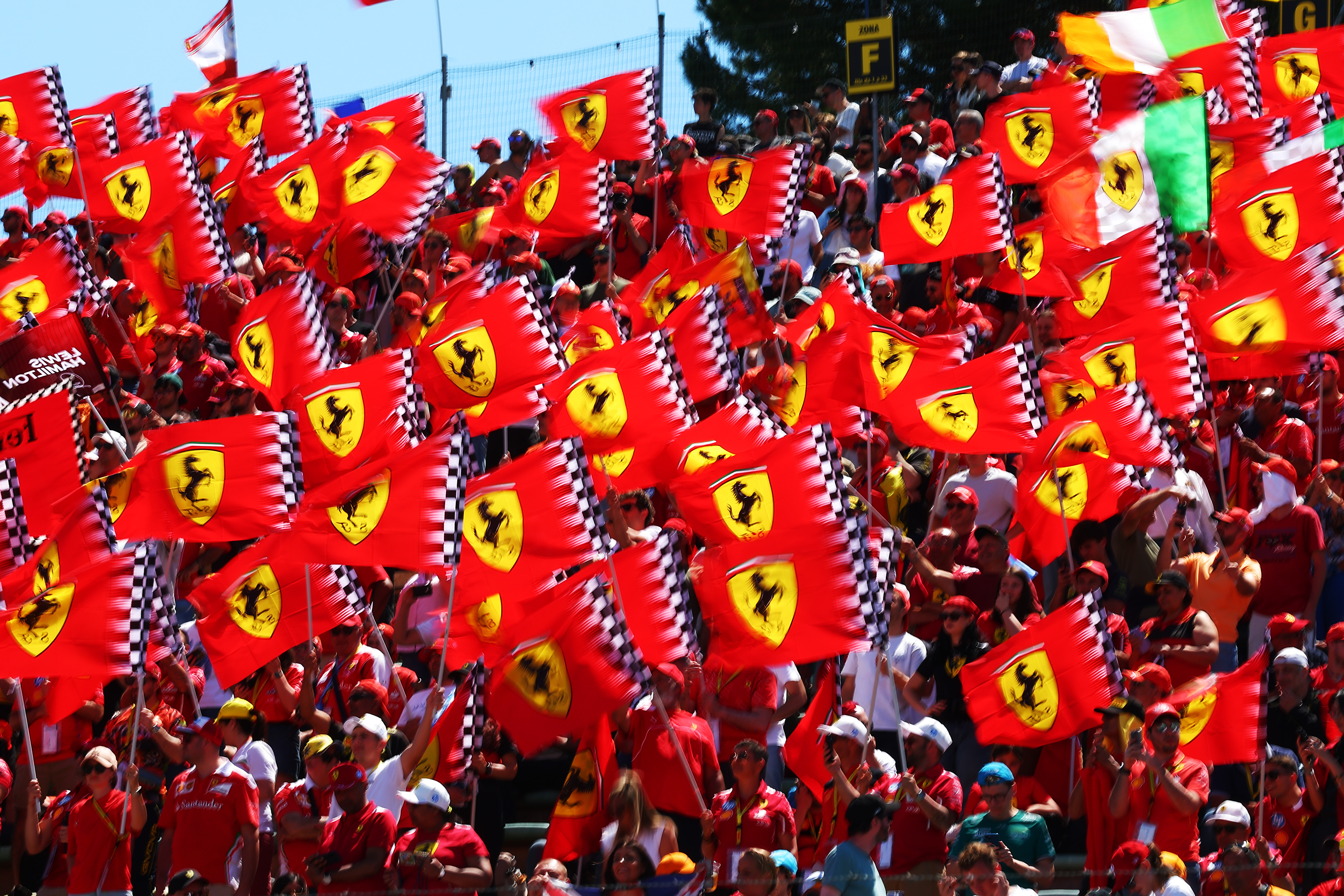 IMOLA, ITALY - MAY 18: Ferrari fans wave their flags in a grandstand prior to the F1 Grand Prix of Emilia-Romagna at Autodromo Internazionale Enzo e Dino Ferrari on May 18, 2025 in Imola, Italy.