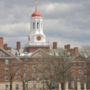 Image of a red brick building with a white spire on Harvard's campus.
