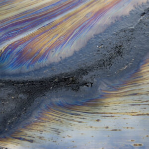 Streaks of iridescent materials suggesting the presence of organic chemicals.