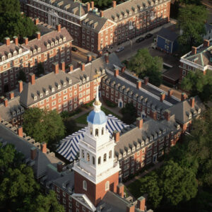 A single white spire amidst several rows of red brick buildings.