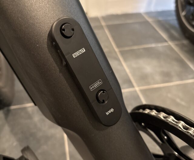 Image of a black plastic oval attached to a grey bike frame.