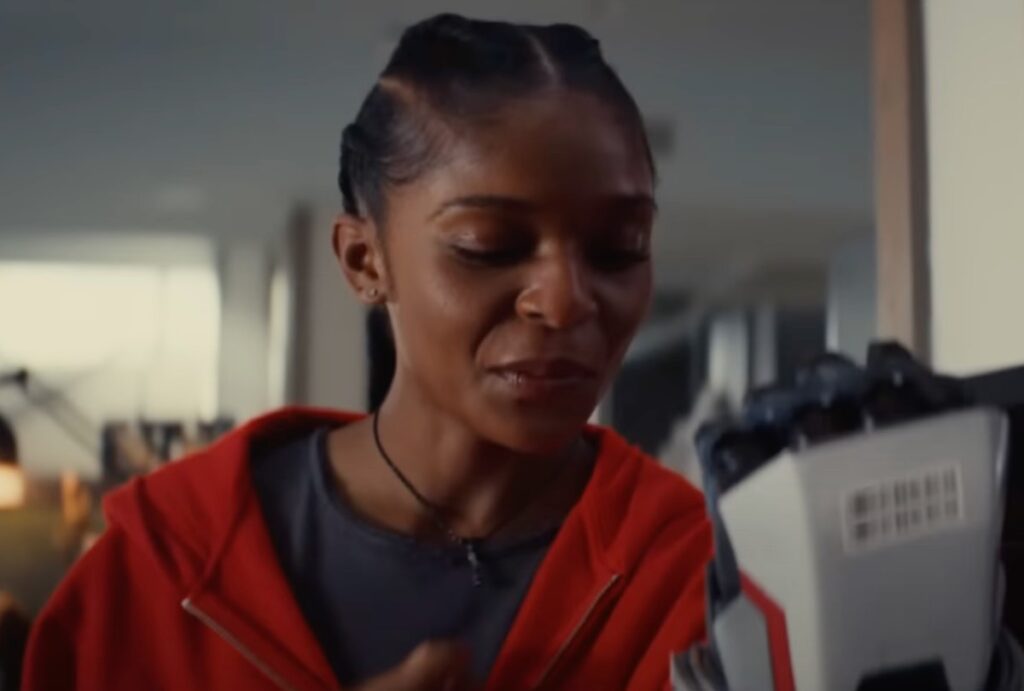 Riri tests a glove for her exoskeleton suit.