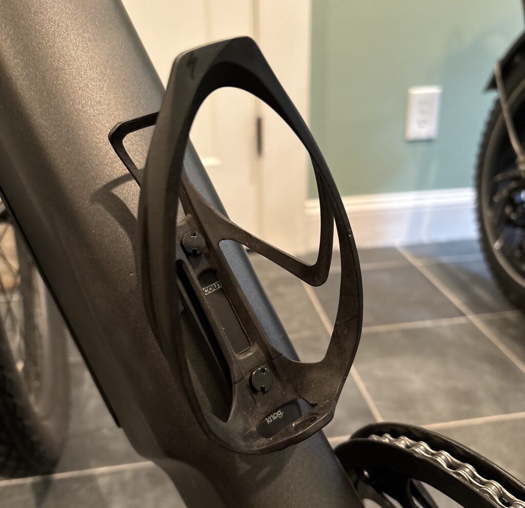 Image of a bicycle frame with a plastic water bottle holder in place.