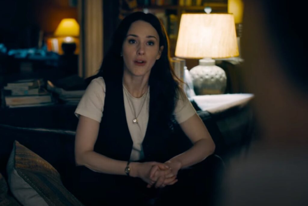 intense young woman with brown hair seated for an interview